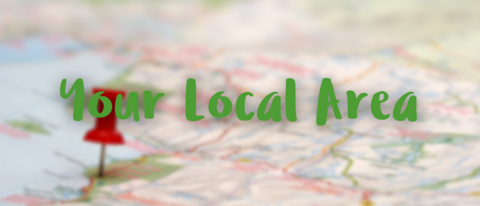 Photo of a map with a pin in it, with the title 'your local area' in green