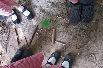 Children stick writing the word WILD