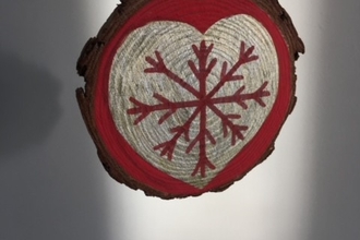 Wooden slice decorated with a gold heart and red snowflake 