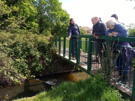 Alex Jones pointing and describing a weir in Lake View Park