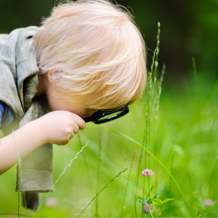 A child looking through a magnifying glass