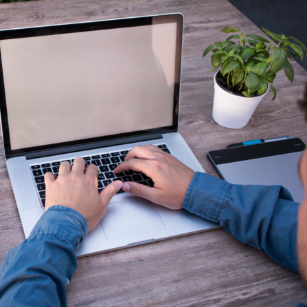 A person typing on a laptop