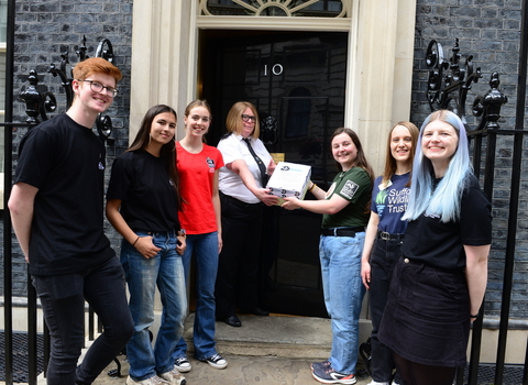 Group of young people handing in a petition at no.10